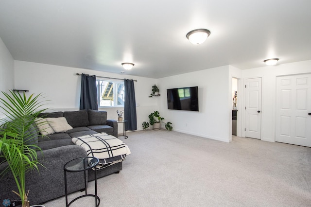 living room featuring light carpet and baseboards