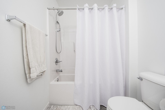 bathroom featuring toilet and shower / bath combination with curtain