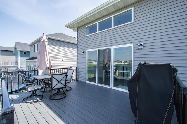 deck featuring a grill and outdoor dining space