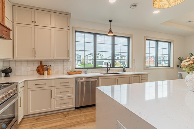 8820 Northern Lights Ave, Fargo, ND 58047 - kitchen with appliances with stainless steel finishes, light wood-type flooring, pendant lighting, recessed lighting, and backsplash