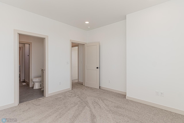 8820 Northern Lights Ave, Fargo, ND 58047 - unfurnished bedroom with carpet flooring, recessed lighting, baseboards, and connected bathroom