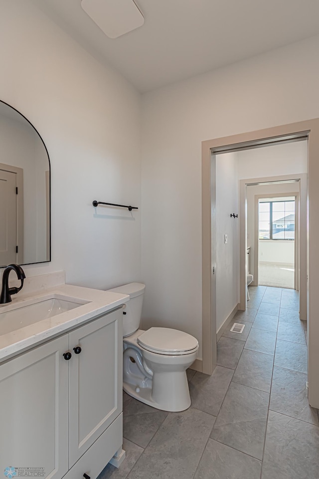 8820 Northern Lights Ave, Fargo, ND 58047 - bathroom with toilet, vanity, and tile patterned floors