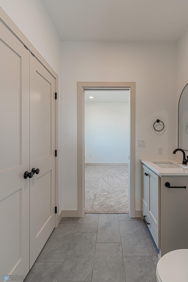 8820 Northern Lights Ave, Fargo, ND 58047 - bathroom featuring toilet, vanity, and baseboards