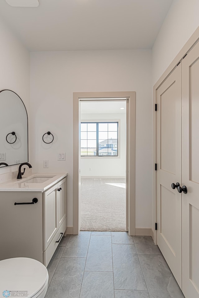 8820 Northern Lights Ave, Fargo, ND 58047 - bathroom with vanity, toilet, and baseboards