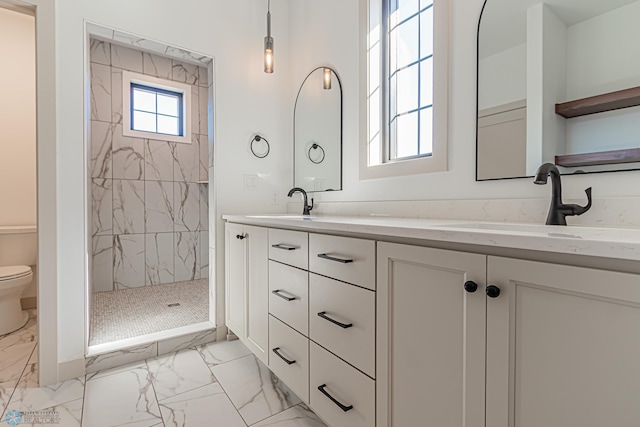 8820 Northern Lights Ave, Fargo, ND 58047 - full bathroom featuring marble look tile flooring, double vanity, toilet, and tiled shower