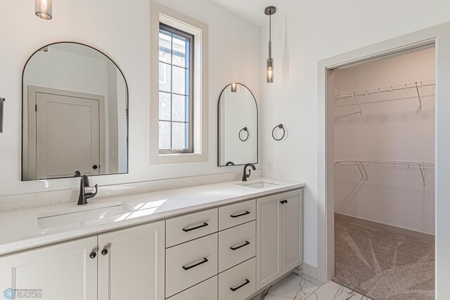 8820 Northern Lights Ave, Fargo, ND 58047 - bathroom featuring double vanity, marble finish floors, and a spacious closet