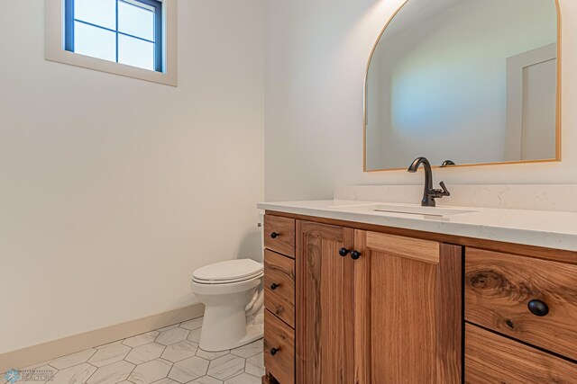 8820 Northern Lights Ave, Fargo, ND 58047 - half bathroom with toilet, vanity, and baseboards