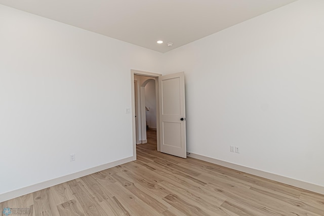 8820 Northern Lights Ave, Fargo, ND 58047 - empty room with light wood-type flooring, baseboards, recessed lighting, and arched walkways