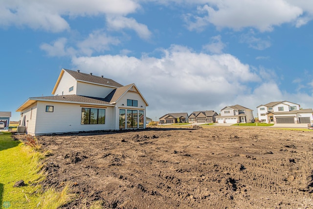 8820 Northern Lights Ave, Fargo, ND 58047 - rear view of house with central AC unit, a residential view, and a shingled roof