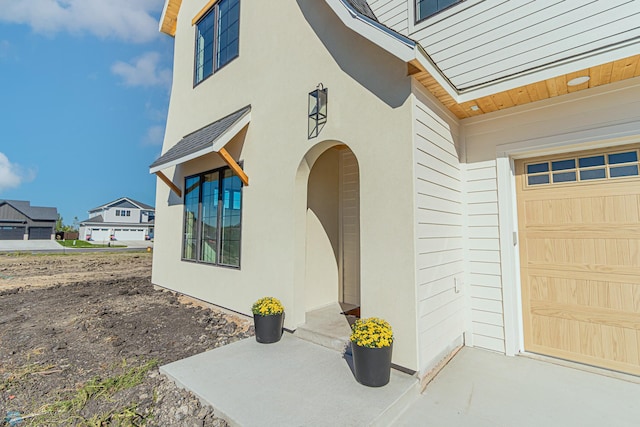 8820 Northern Lights Ave, Fargo, ND 58047 - doorway to property with a garage and stucco siding