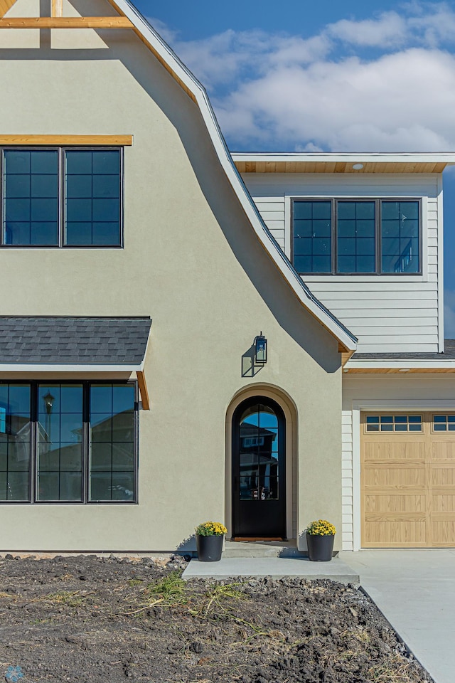 8820 Northern Lights Ave, Fargo, ND 58047 - view of front of home with stucco siding, a garage, and driveway
