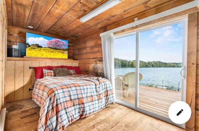 2132 295th Ave, Luck, WI 54853 - bedroom with access to exterior, wood finished floors, a water view, wooden ceiling, and wooden walls