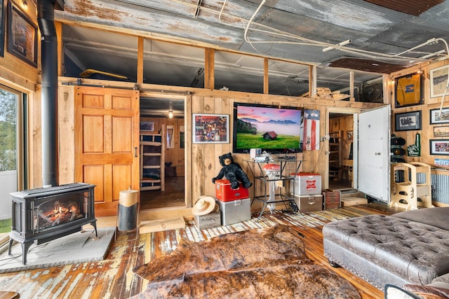 2132 295th Ave, Luck, WI 54853 - living room with a wood stove, wood-type flooring, and wooden walls