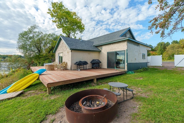 2132 295th Ave, Luck, WI 54853 - rear view of house featuring a fire pit, a deck, and roof with shingles