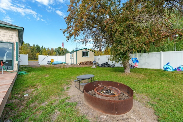 2132 295th Ave, Luck, WI 54853 - view of yard featuring a fire pit, an outbuilding, a storage shed, and a deck