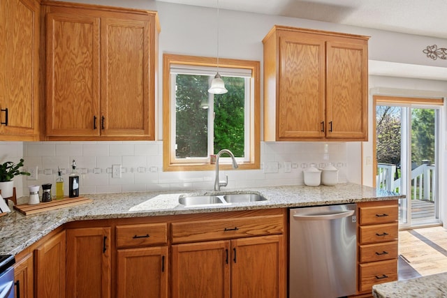 2011 Silver St, Waconia, MN 55387 - kitchen featuring stainless steel dishwasher, a sink, backsplash, and light stone counters