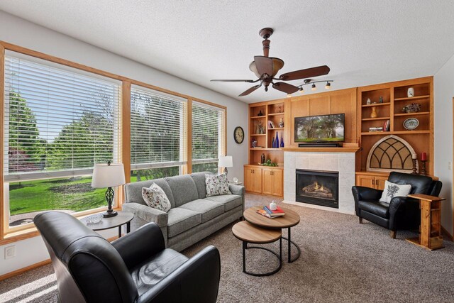2011 Silver St, Waconia, MN 55387 - living room featuring ceiling fan, a textured ceiling, carpet floors, a fireplace, and built in features