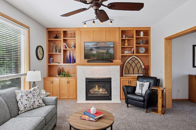 2011 Silver St, Waconia, MN 55387 - carpeted living area featuring healthy amount of natural light, a ceiling fan, a tile fireplace, and built in features
