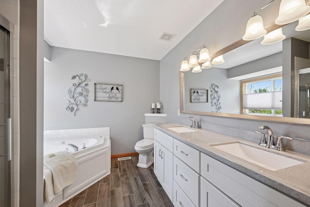 2011 Silver St, Waconia, MN 55387 - bathroom featuring a shower with door, double vanity, toilet, baseboards, and a bath