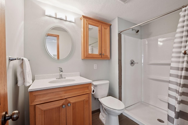 2011 Silver St, Waconia, MN 55387 - full bathroom with a shower with curtain, vanity, toilet, and a textured ceiling