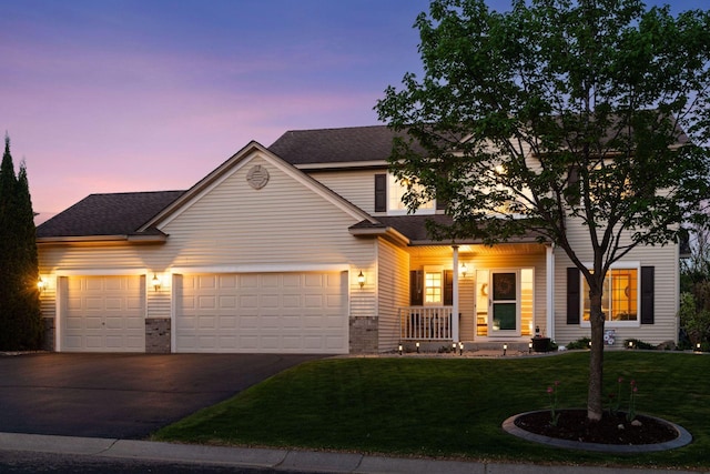 2011 Silver St, Waconia, MN 55387 - view of front of home featuring concrete driveway, covered porch, a yard, an attached garage, and a shingled roof