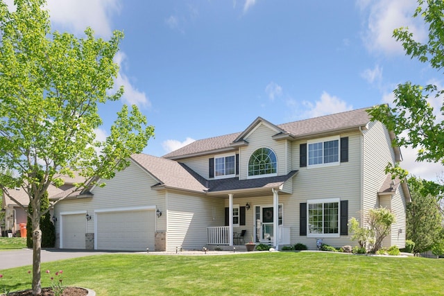 2011 Silver St, Waconia, MN 55387 - view of front of property with covered porch, a front yard, a garage, asphalt driveway, and roof with shingles