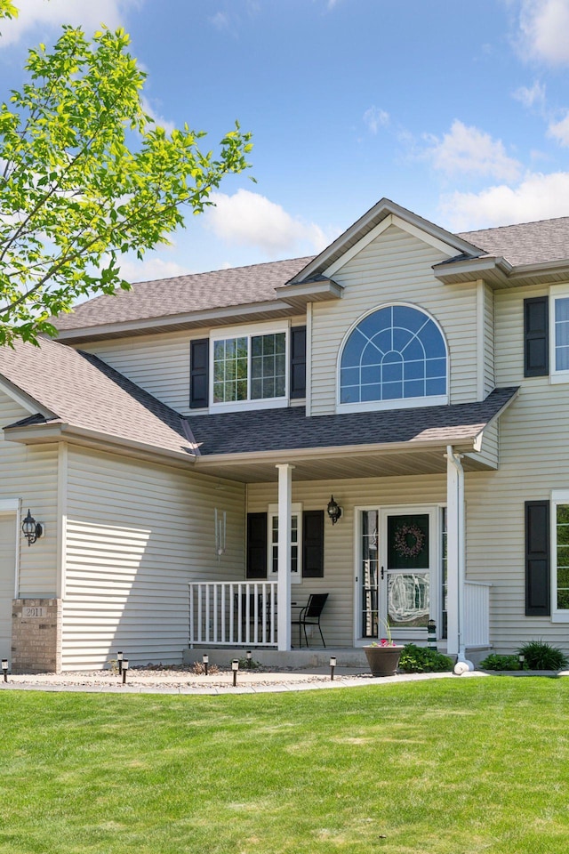 2011 Silver St, Waconia, MN 55387 - view of front of property featuring covered porch, a front yard, and a shingled roof