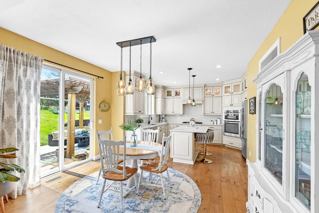 dining area featuring light wood-style flooring