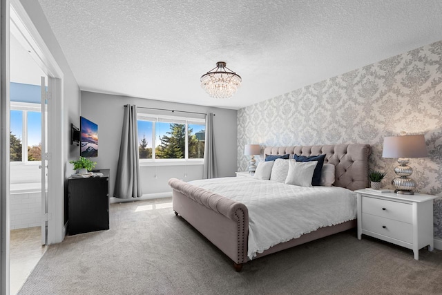 bedroom featuring wallpapered walls, a chandelier, a textured ceiling, carpet floors, and baseboards