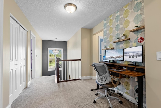 office with a textured ceiling, carpet floors, and baseboards