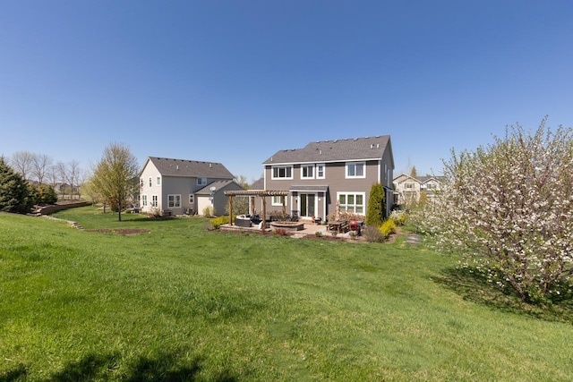 back of property with a patio, a yard, and a pergola