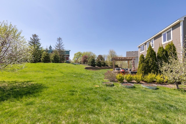 view of green lawn featuring a pergola