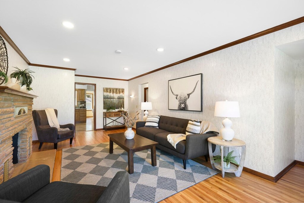 5627 Lake St, Saint Louis Park, MN 55416 - living room with wood finished floors, a fireplace, ornamental molding, recessed lighting, and baseboards