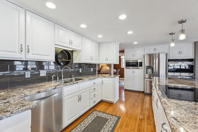 1683 Hansack Ave NE, Saint Michael, MN 55376 - kitchen featuring stainless steel appliances, a sink, white cabinetry, tasteful backsplash, and recessed lighting