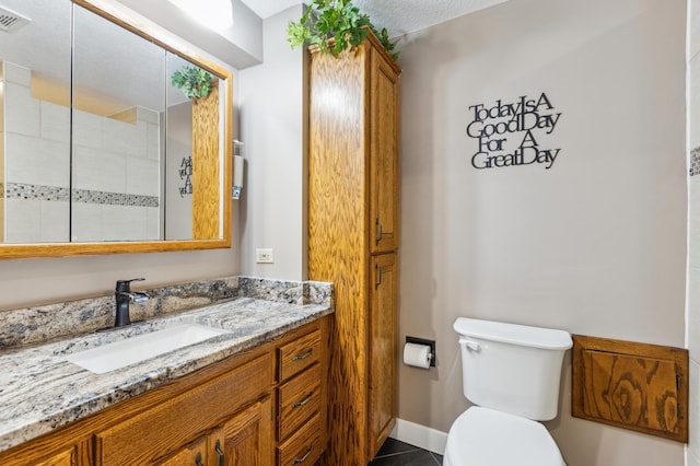 1683 Hansack Ave NE, Saint Michael, MN 55376 - full bathroom featuring toilet, vanity, tiled shower, tile patterned flooring, and baseboards
