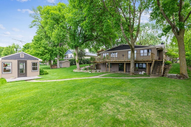 1683 Hansack Ave NE, Saint Michael, MN 55376 - rear view of property featuring stairs, a wooden deck, an outdoor structure, and a lawn