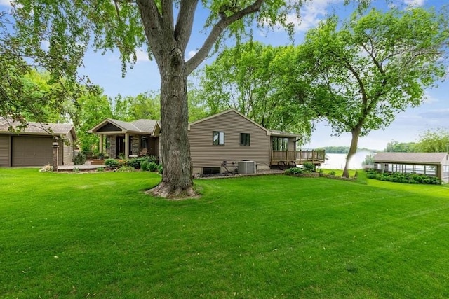 1683 Hansack Ave NE, Saint Michael, MN 55376 - rear view of property with a yard, central AC, a garage, and a deck with water view