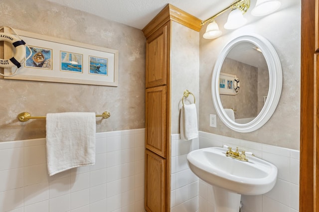 1683 Hansack Ave NE, Saint Michael, MN 55376 - bathroom with tile walls, a sink, and a wainscoted wall