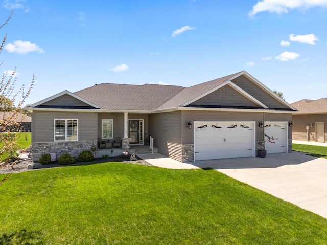 2006 13th Ave NE, Austin, MN 55912 - view of front facade with stone siding, a garage, a front lawn, and concrete driveway