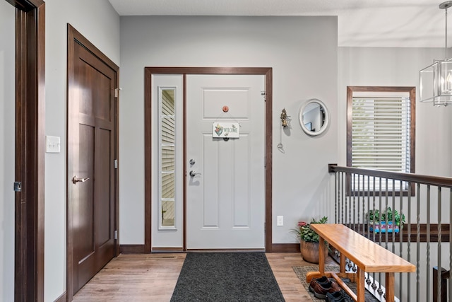 2006 13th Ave NE, Austin, MN 55912 - foyer entrance featuring light wood-style floors, a chandelier, and baseboards