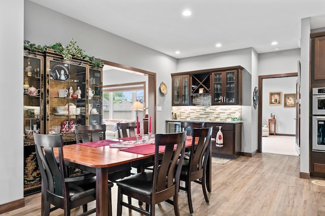 2006 13th Ave NE, Austin, MN 55912 - dining room with light wood finished floors, bar, and recessed lighting