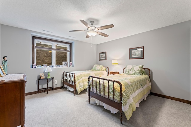 2006 13th Ave NE, Austin, MN 55912 - bedroom with light carpet, baseboards, a ceiling fan, and a textured ceiling