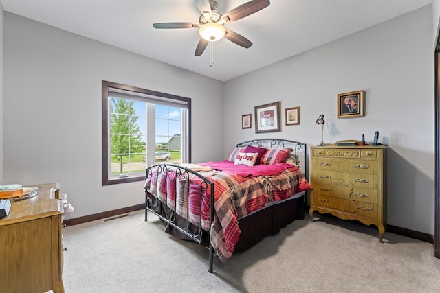 2006 13th Ave NE, Austin, MN 55912 - bedroom featuring light colored carpet, baseboards, and ceiling fan