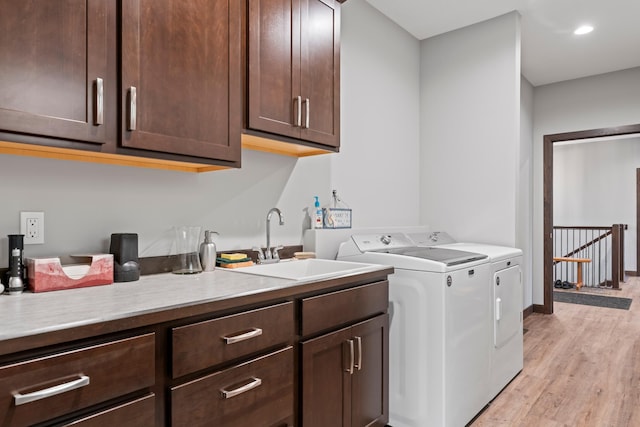 2006 13th Ave NE, Austin, MN 55912 - washroom with washer and clothes dryer, cabinet space, and light wood-style flooring