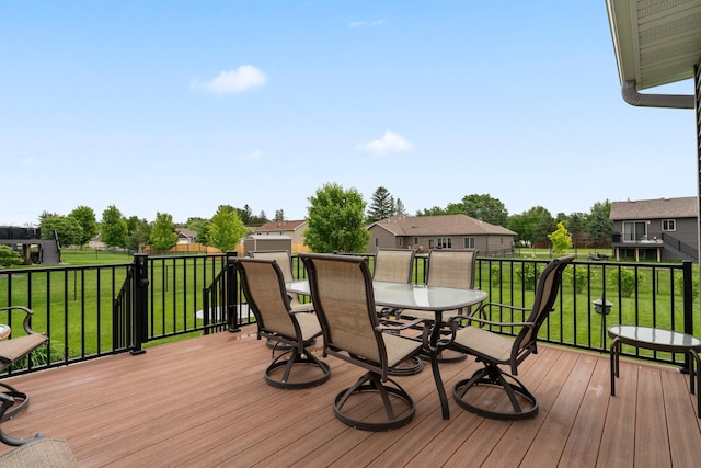 2006 13th Ave NE, Austin, MN 55912 - wooden deck with outdoor dining area and a yard