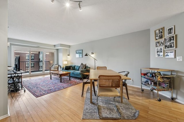 living area featuring light wood-type flooring and baseboards