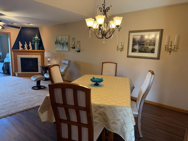 522 Delaware St SW, Lonsdale, MN 55046 - dining space with dark wood-type flooring, a chandelier, ceiling fan, baseboards, and a fireplace