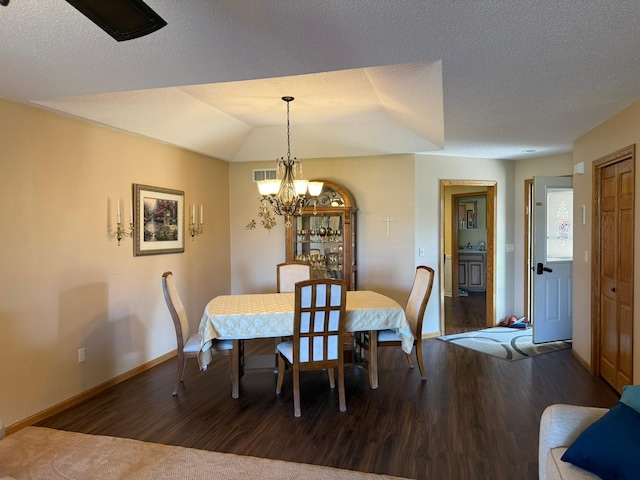 522 Delaware St SW, Lonsdale, MN 55046 - dining room with a chandelier, baseboards, wood finished floors, and a textured ceiling