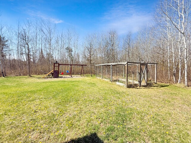 view of green lawn with a playground