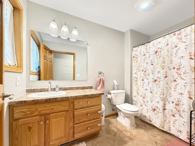 bathroom featuring toilet, vanity, tile patterned flooring, and a shower with shower curtain